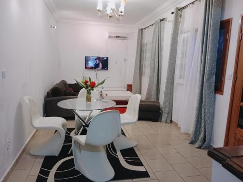 a living room with a white table and chairs at Résidence Hôtelière l'Océane in Kribi