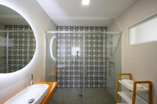 a bathroom with a shower and a sink at Ericeira TreeGarden in Ericeira