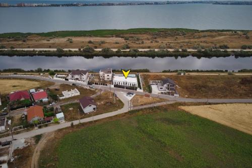 an aerial view of a road with a yellow arrow at Peninsula Luxury & Spa in Năvodari