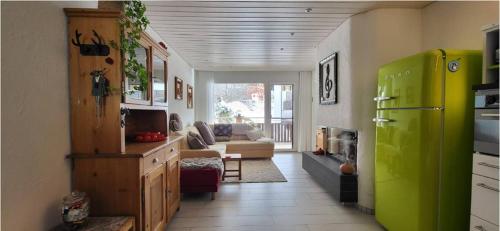 a kitchen with a green refrigerator and a couch at Cozy 2 Room Appartment In Laax in Laax