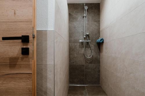 a bathroom with a shower with a glass door at Apart GuetGeanLossn in Längenfeld