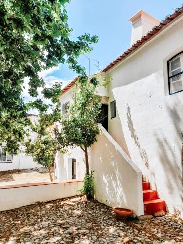 a white house with a staircase in front of it at O Conventinho in Évora