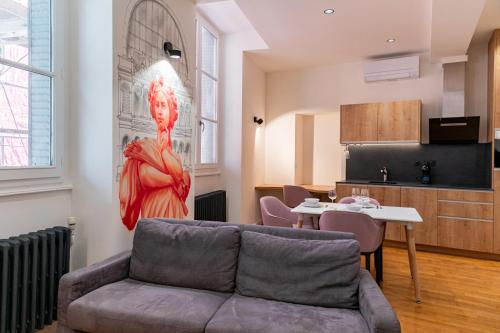 a living room with a couch and a table at Croix Paquet - Appartements à Lyon in Lyon