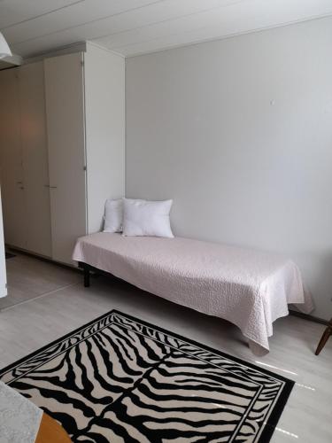 a bedroom with a bed with a zebra print rug at Laaksotie in Heinävesi