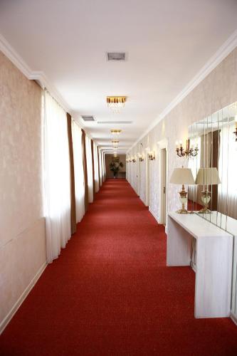 a hallway with a red carpet and a long corridor at Deluxe Hotel Ganja in Ganja