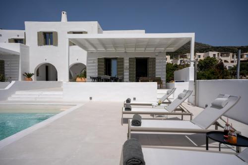 a villa with a swimming pool and a house at Paros Breeze Luxury Villa in Drios