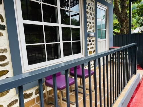 a house with purple stools on a porch at The Yakshaa Kumartha in Rishīkesh