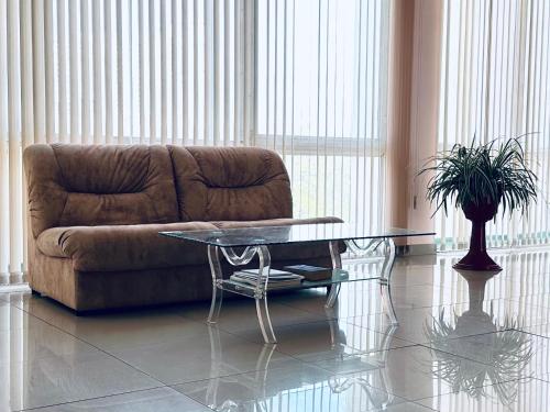 a living room with a couch and a glass table at Blaz in Odesa