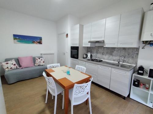 a kitchen and living room with a table and chairs at Lela's room in Bari