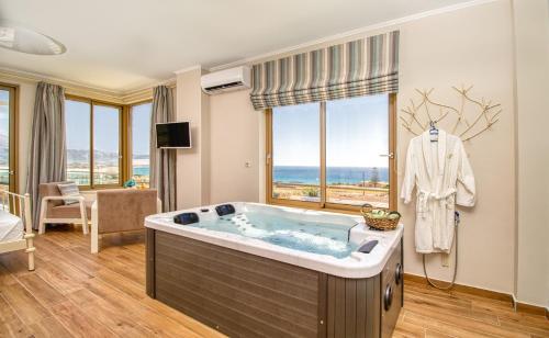 a jacuzzi tub in a room with a view at Villa Kore Luxuryvillaschania in Falasarna