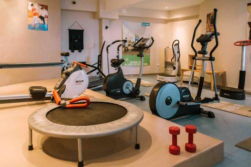a room with a gym with a treadmill and exercise equipment at Villa Mariale by Popinns in Lourdes