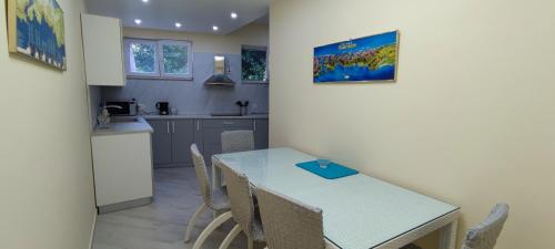 a kitchen and dining room with a table and chairs at Lastva star in Donja Lastva