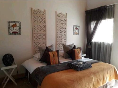 a bedroom with a large bed in a room at de Klerens Gems Topaz Self Catering Studio in Clarens