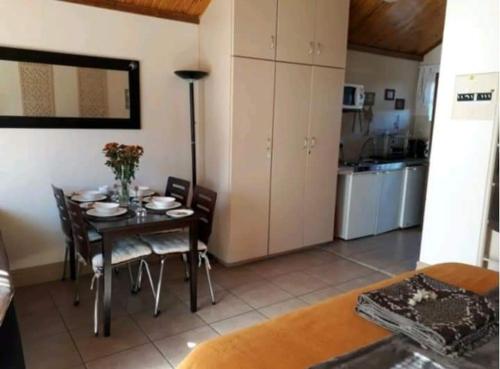 a kitchen and dining room with a table and chairs at de Klerens Gems Topaz Self Catering Studio in Clarens