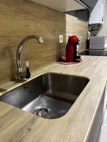 a kitchen sink with a red appliance on the counter at San Andres in Zamora