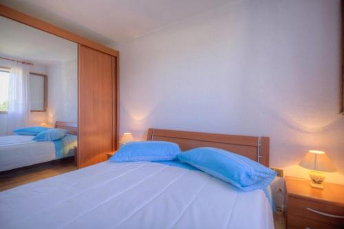 a bedroom with two blue pillows on a bed at Casa Cerin with Private Pool in Barat