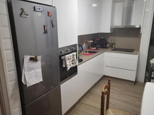 a kitchen with a stainless steel refrigerator at D&L 3 piso compartido in Vigo