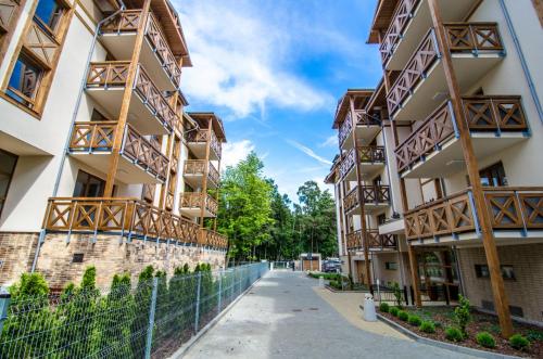 an empty street in front of apartment buildings at Rezydencja Park Mielno in Mielno