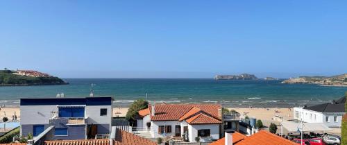 vistas a una playa con casas y al océano en Los Castellanos nº 8 Suances, en Suances