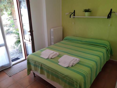 a bedroom with a bed with two towels on it at Il Parco in Ancona