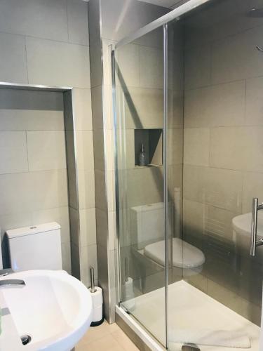 a bathroom with a glass shower and a toilet at Arrandale Guest House in Edinburgh