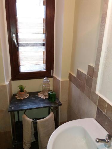 a bathroom with a sink and a toilet and a window at Terme e relax nella campagna viterbese in Viterbo