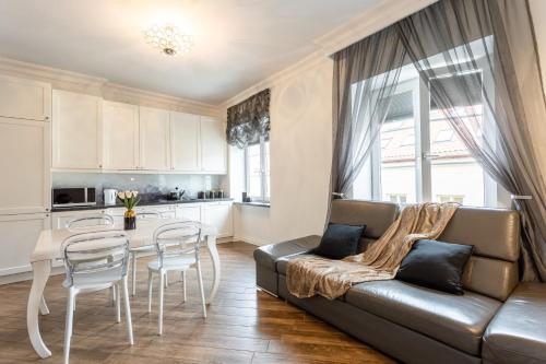 a living room with a couch and a table at Golden Apartments Warsaw - Stylish and Luxury Apartment - Podwale in Warsaw
