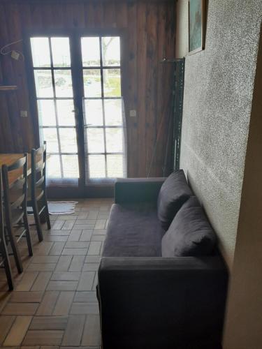 a couch sitting in a room with a window at Burguet in Campan