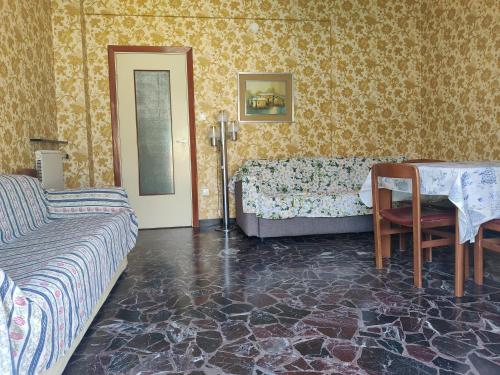 a bedroom with a bed and a table and a couch at Top-Location-bright-fastWI-FI in Sestri Levante