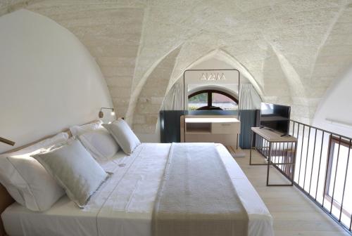 a bedroom with a bed and a sink in a room at Carrubia in Nardò