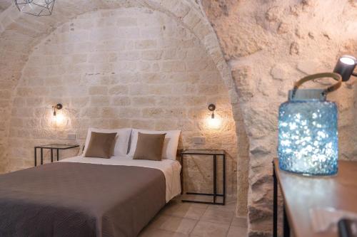 a bedroom with a bed in a stone wall at Cà del Centro in Manfredonia