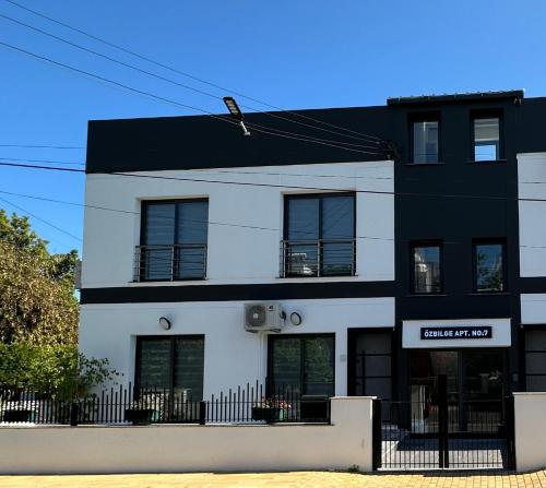 a black and white building with a black at Ozbilge Apartments in Kyrenia