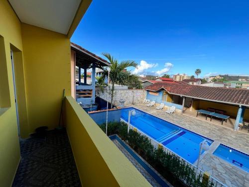 a view of a swimming pool from the balcony of a house at Pousada Caraguá in Caraguatatuba