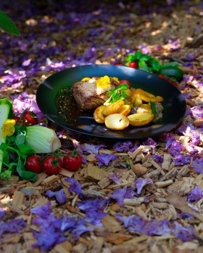 a plate of food with meat and vegetables on the ground at Hirschen Eggiwil in Eggiwil