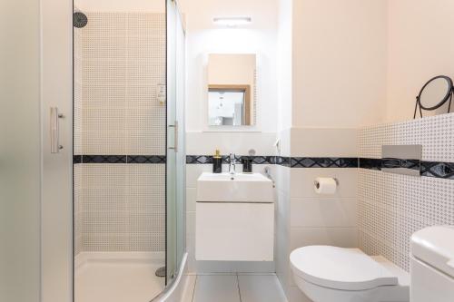 a bathroom with a shower and a toilet and a sink at Golden Apartments Warsaw - Big Luxury Apartment in the Center - Kolejowa in Warsaw