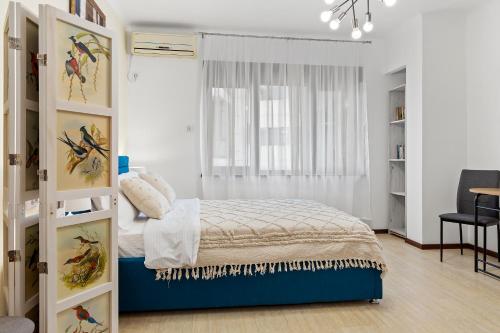 a small bedroom with a bed and a window at Upscale Studio, Walking Distance from The Old Town in Bucharest