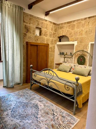 a bedroom with a bed in a brick wall at All’ombra del museo in Tarquinia