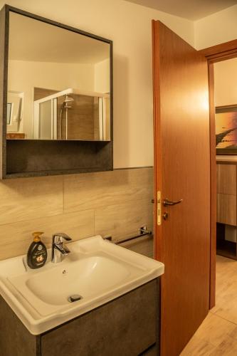 a bathroom with a sink and a mirror at Appartamenti Edolo - A 20 minuti da Ponte di Legno e Aprica in Edolo