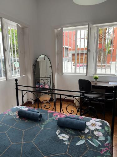 a bedroom with a bed and a table and a mirror at Nomad Villa Santa Fe in Las Palmas de Gran Canaria