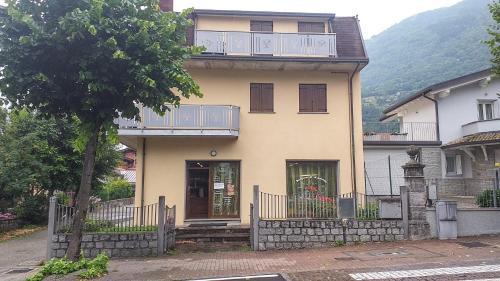 a house with a balcony on top of it at Appartamenti Edolo - A 20 minuti da Ponte di Legno e Aprica in Edolo