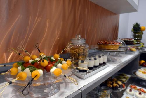 a buffet with fruit and other food on a table at Best Western Hotel Principe di Lampedusa in Palermo