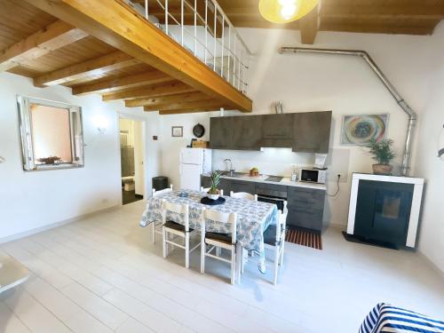 a kitchen with a table with chairs and a kitchen with at Casa Lo Chef - ArgonautiVacanze in Portoferraio