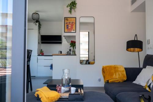 un salon avec un canapé bleu et une table dans l'établissement PWS - Sunny modern flat near Juan Les Pins Pinede & beach - Terrace & AC!, à Antibes