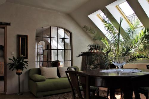 a living room with a table and a green couch at Dvorec Černiv in Černiv