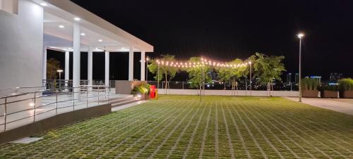 a lit up patio at night with a tent at MVISTA 3BR AirportView CozyStay in Bayan Lepas