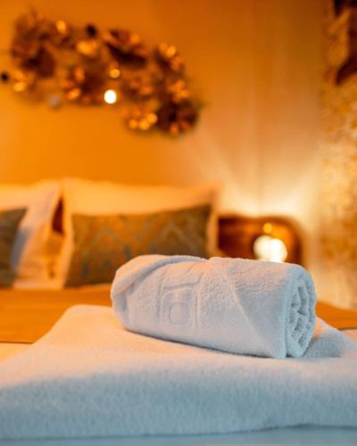 a white towel sitting on top of a bed at Toplik Village Resort in Lukavica