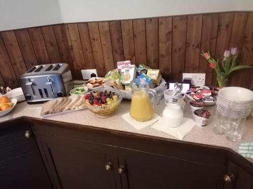 a kitchen counter with breakfast foods and drinks on it at The Royal Norfolk Hotel in Folkestone