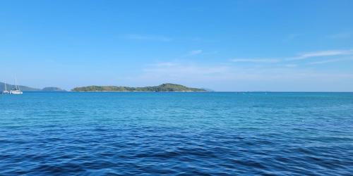 a large body of water with an island in the distance at Phuket Meet Holiday Hotel-Rawai 普吉岛相遇花园度假酒店-拉威店 in Rawai Beach