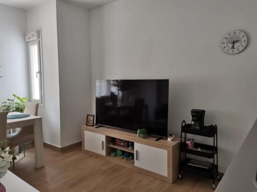 a living room with a large flat screen tv at RockSide Residences Suites La Línea A8 in La Línea de la Concepción