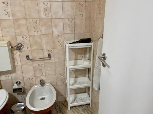 a bathroom with a toilet and a sink at Old Town Cozy Apartment in Porto